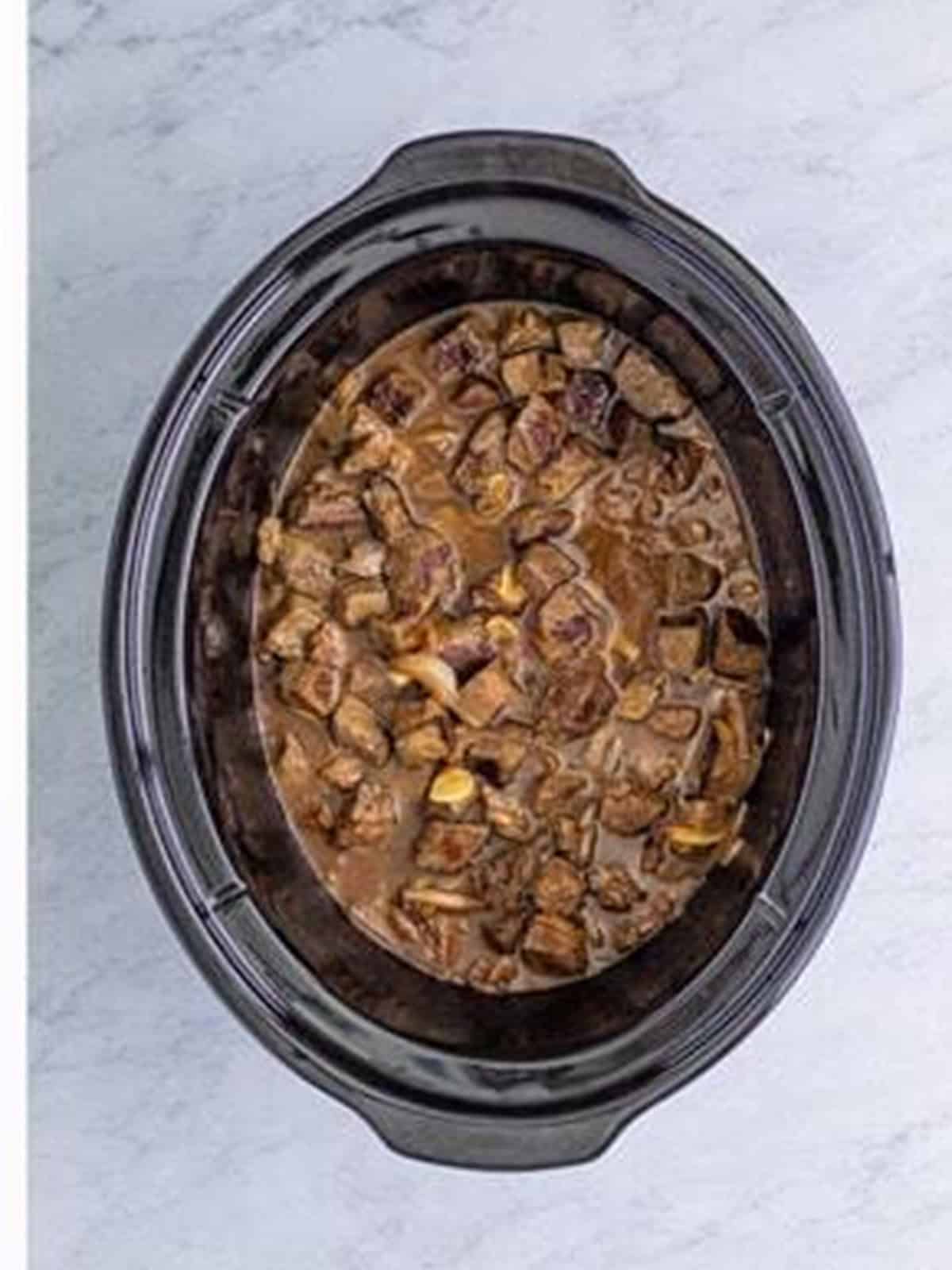 Finished tender slow cooker steak bites in the crock pot.