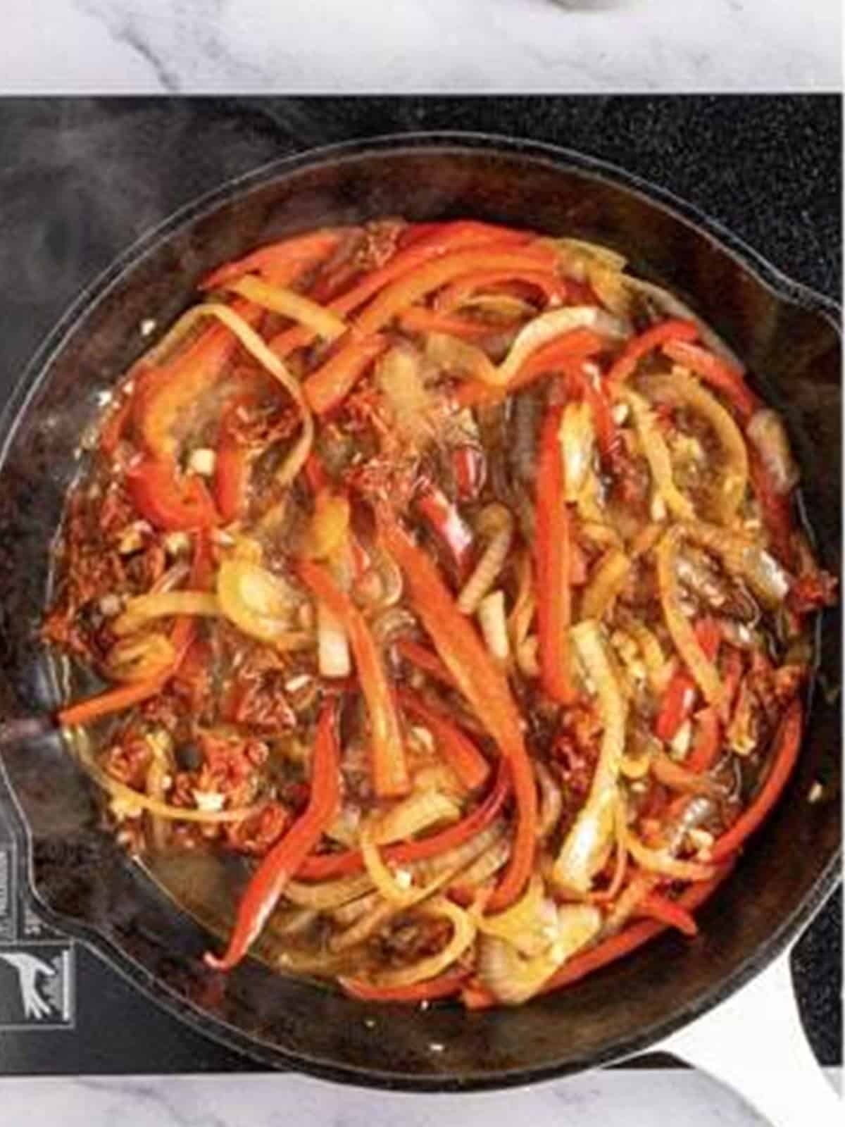 Tomato sauce and sundried tomatoes added to the peppers and onion.
