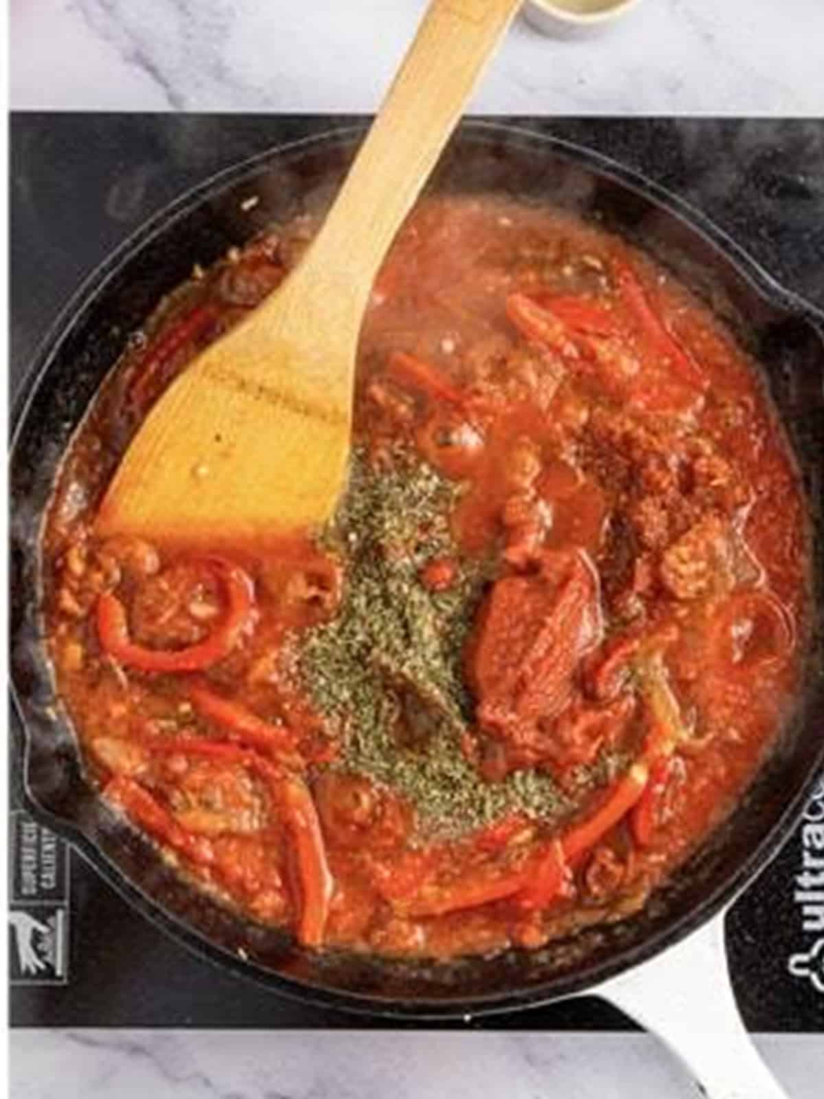 Italian herbs and seasonings stirred into the simmering pizzaiola sauce.