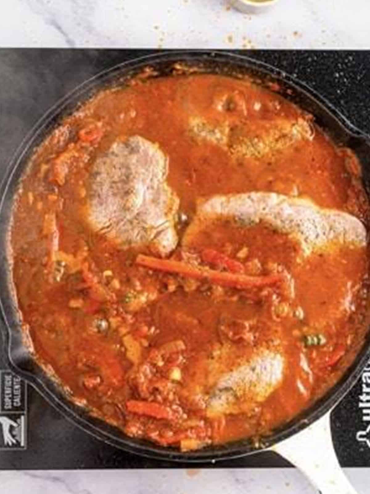Seared ribeye steaks returned to the tomato pizzaiola sauce to simmer.
