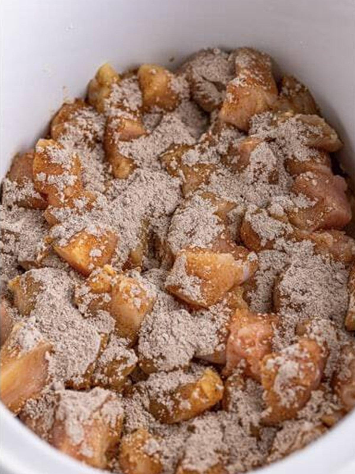 Au jus gravy mix sprinkled over chicken bites in a slow cooker.