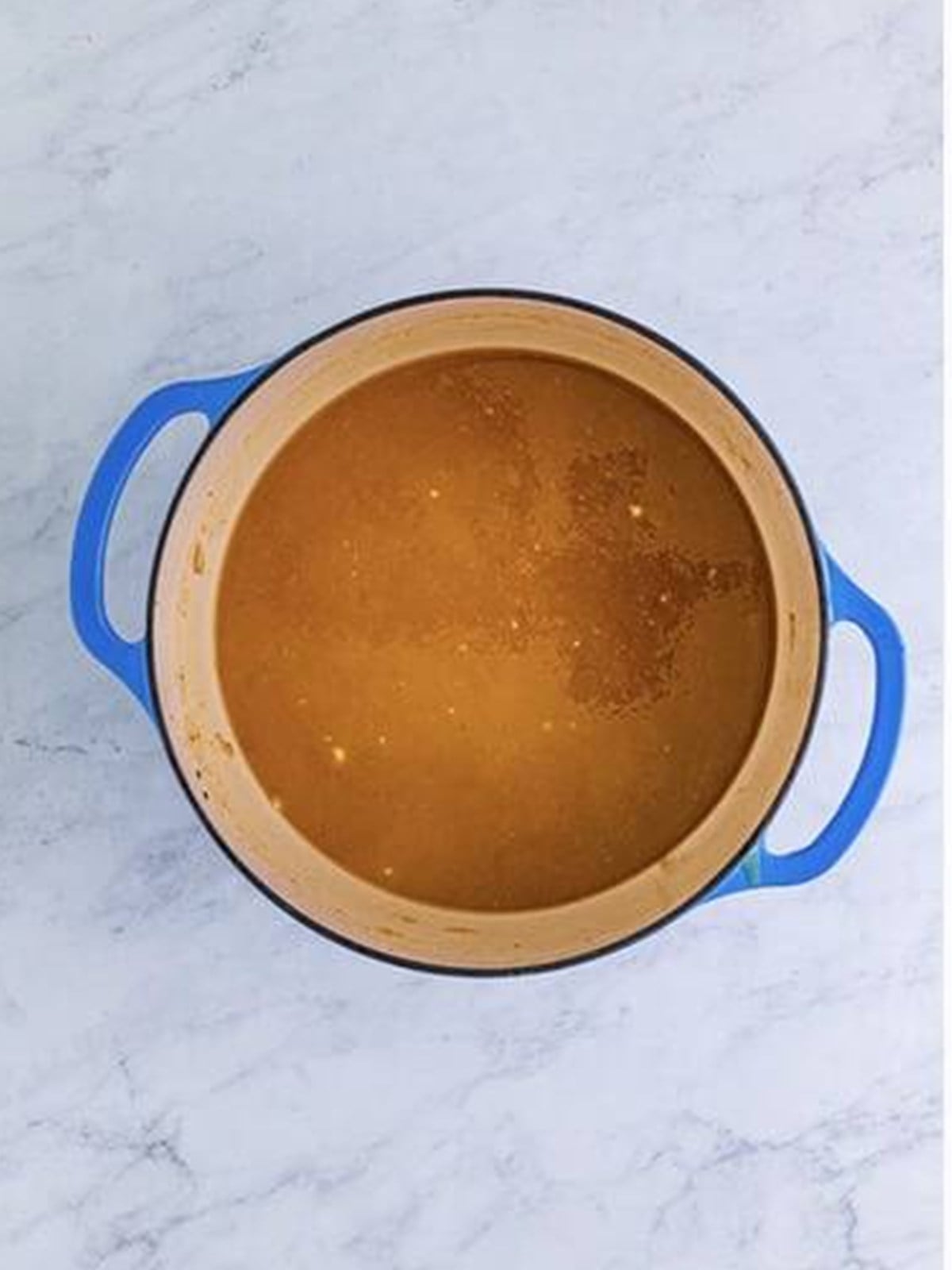 Beef stock whisked into the roux to form a smooth gravy.