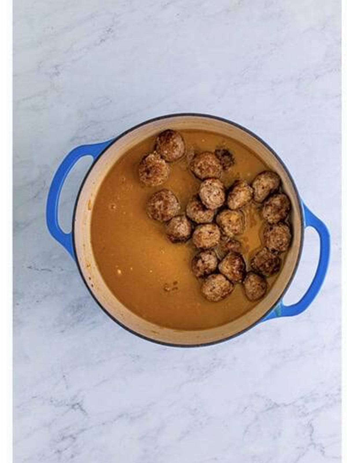 Browned meatballs added back into the onion gravy.
