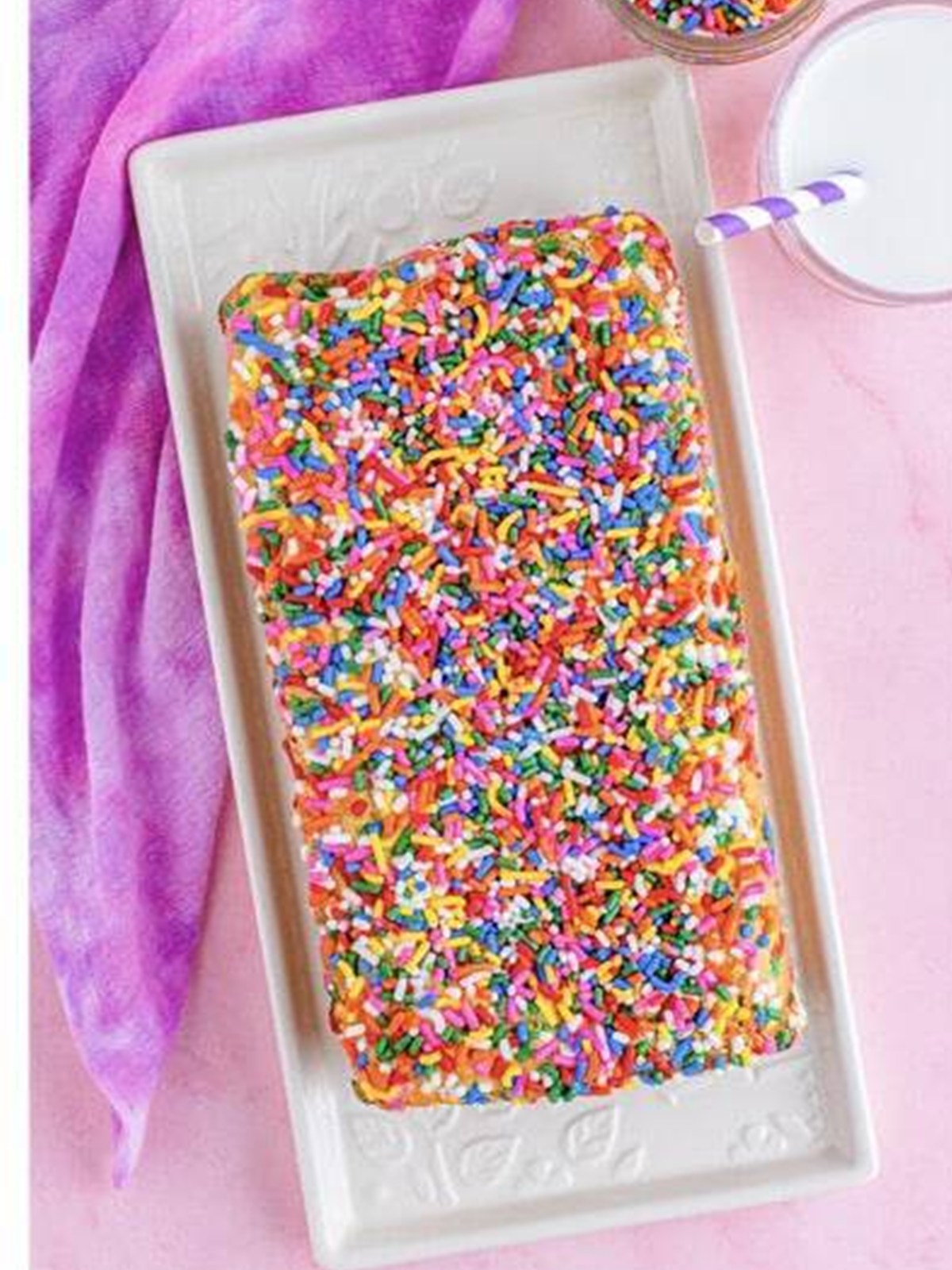 Baked funfetti ice cream bread loaf topped with sprinkles.