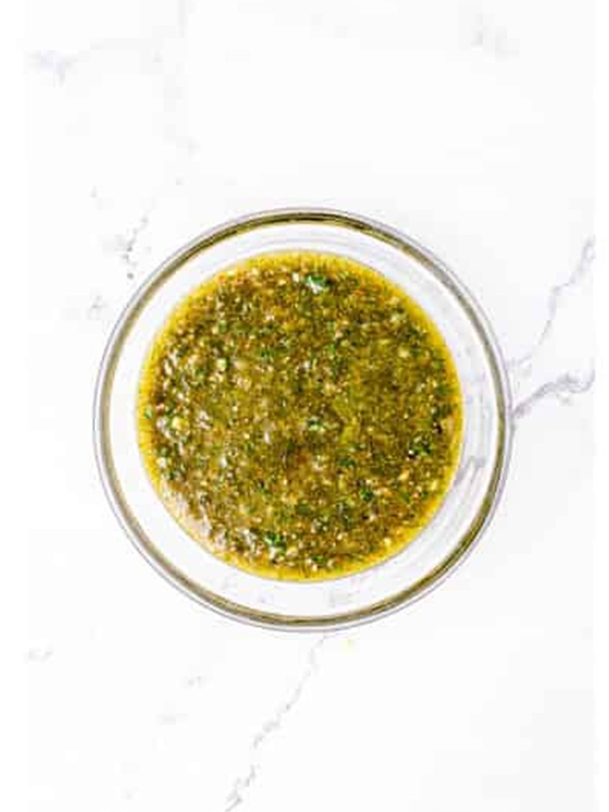 Blended lemon garlic herb marinade in a bowl for grilled chicken wings.