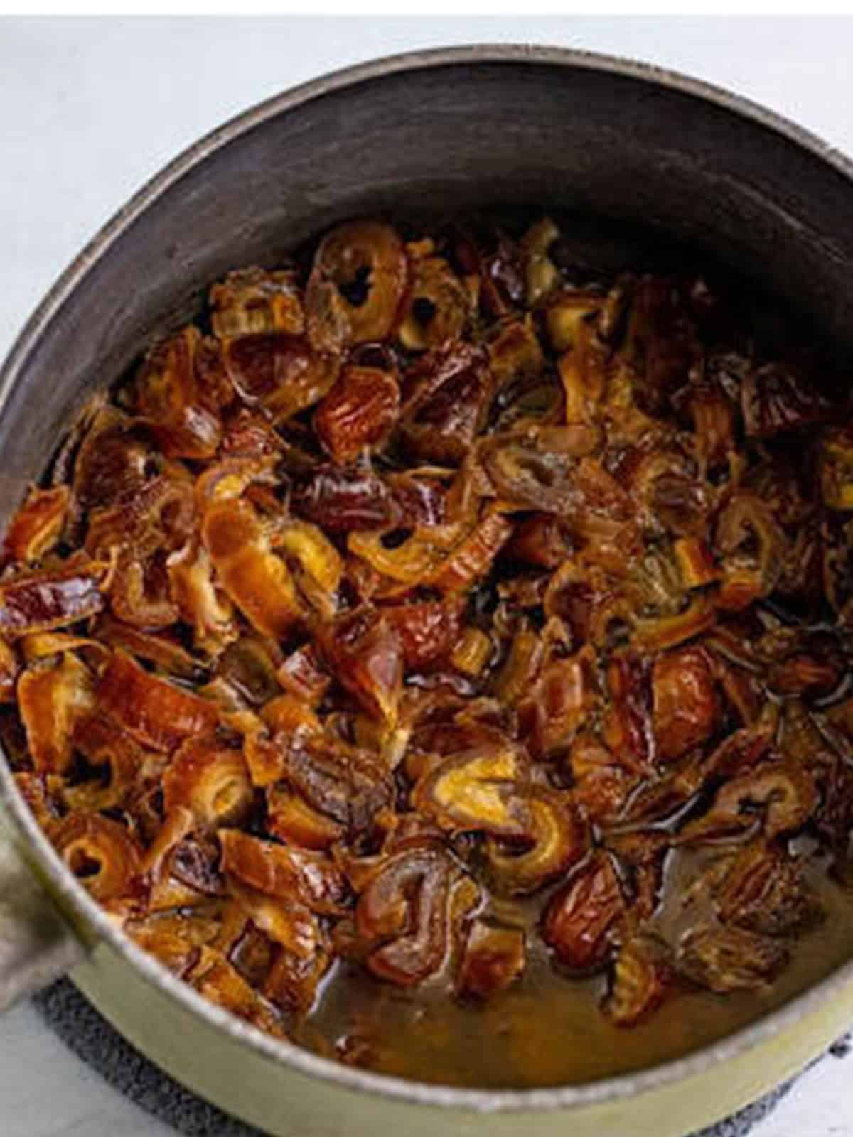 Chopped dates soaking in boiling water for sticky toffee pudding.