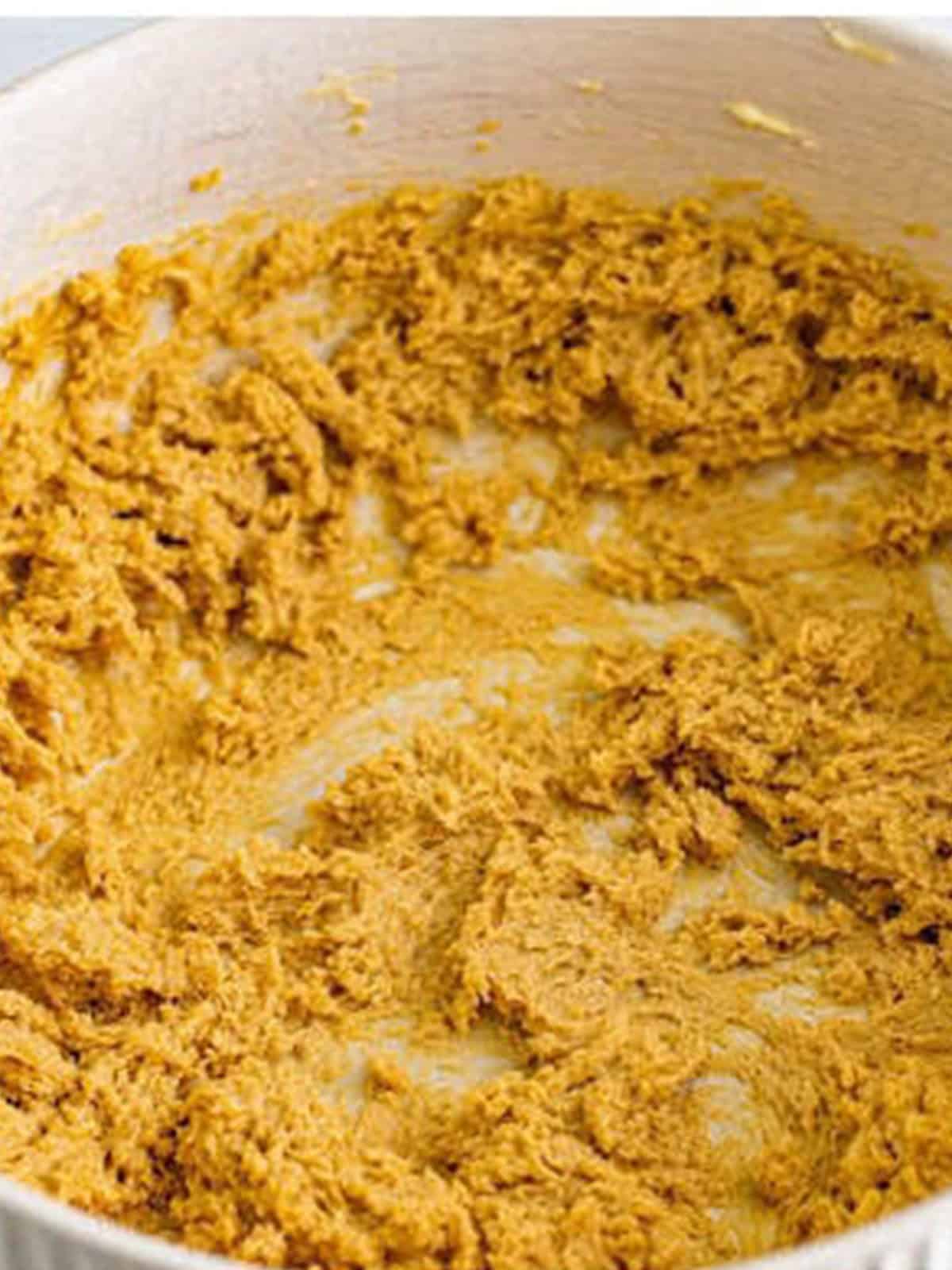 Butter and sugars creamed together with eggs for sticky toffee pudding batter.