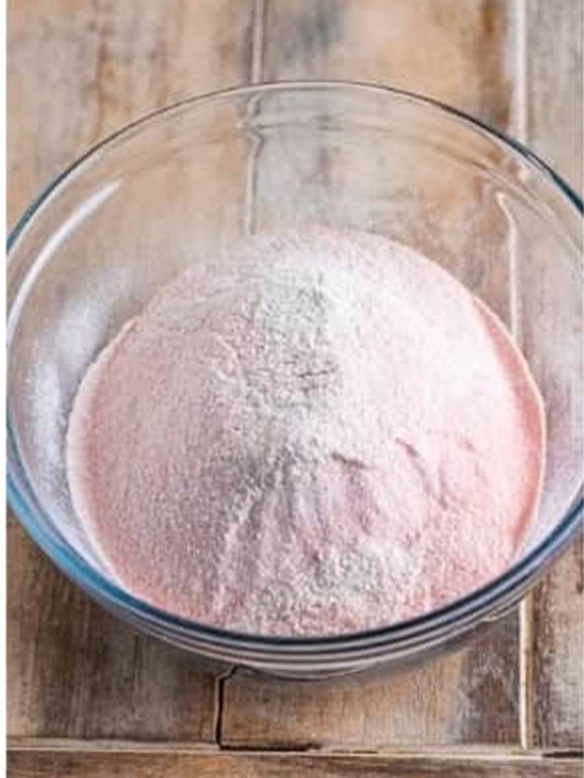 Sifted flour, sugar, and salt in a glass bowl for angel food cake.