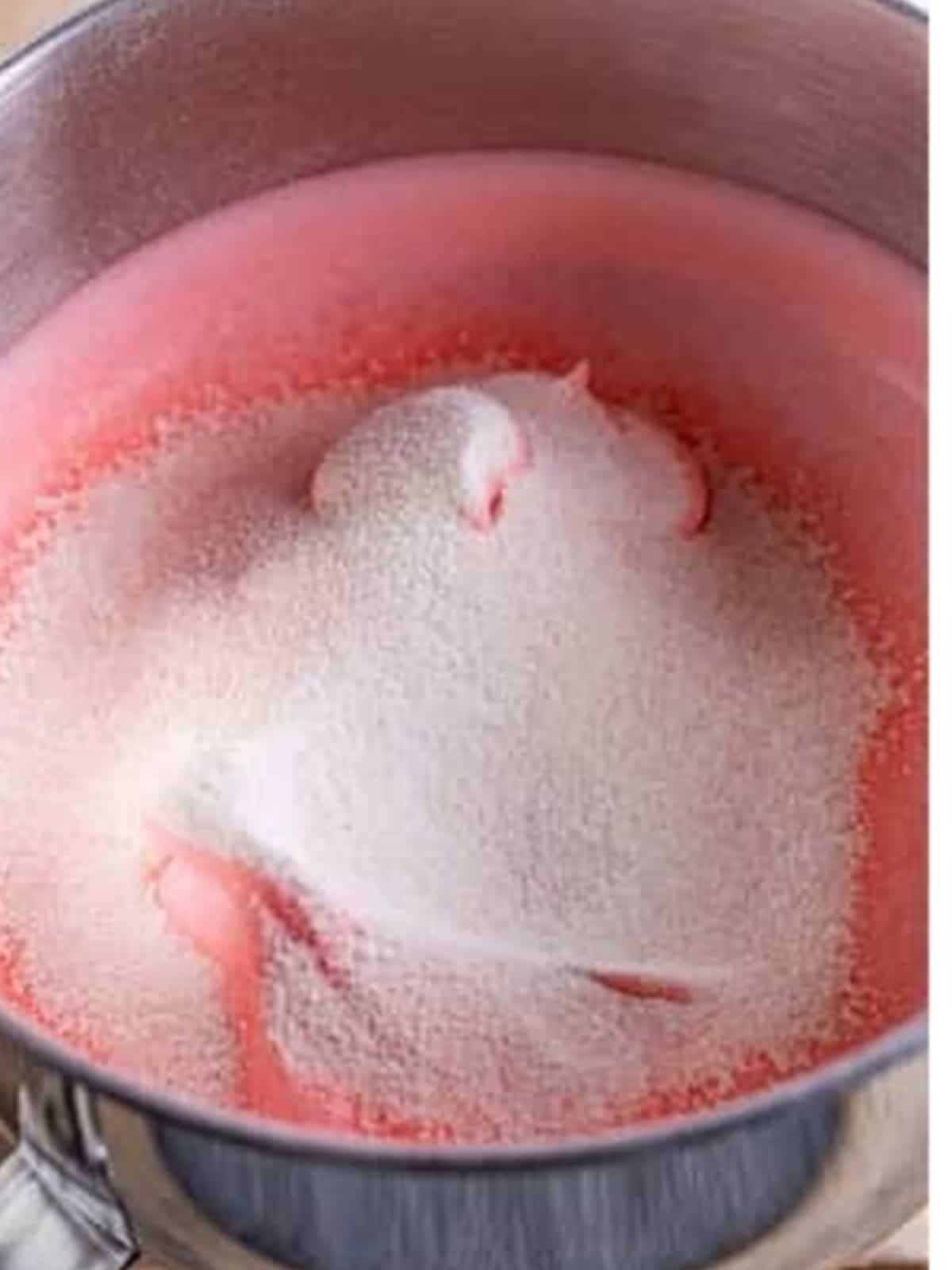 Pink strawberry sugar streamed over whipped egg whites.