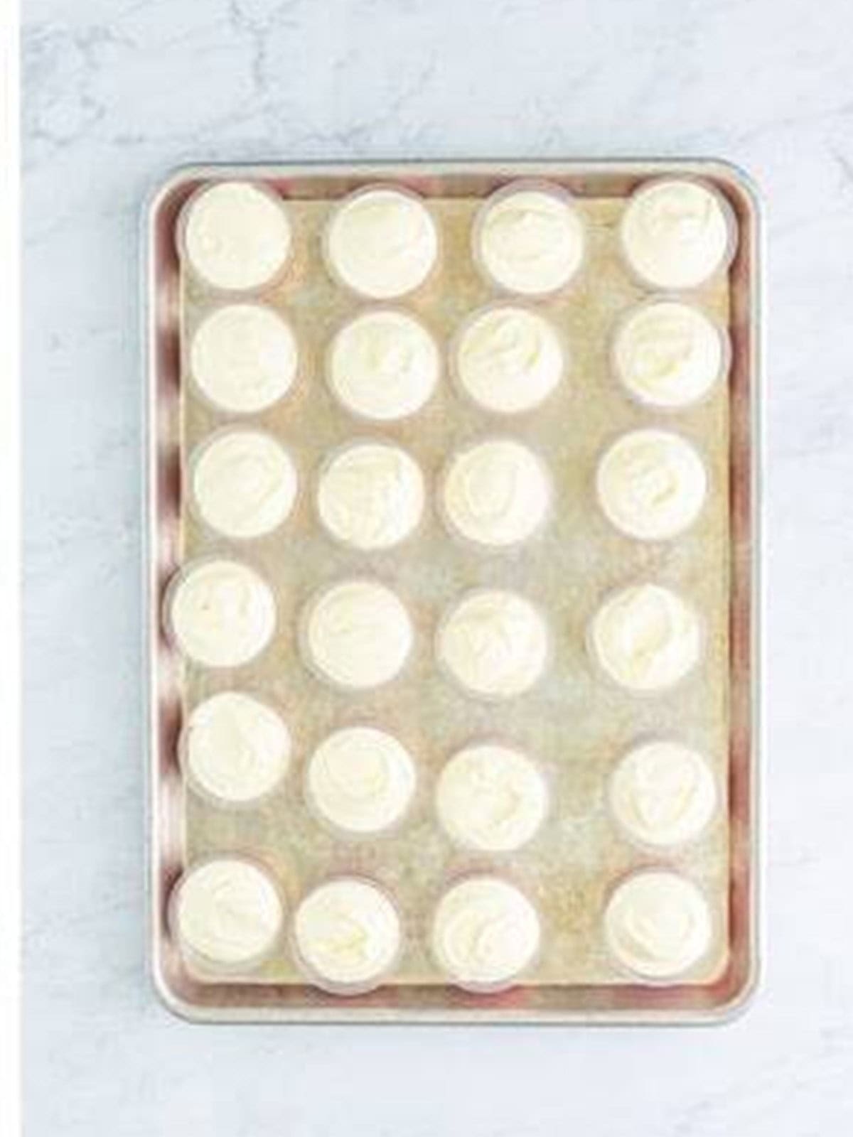Banana pudding layer added on top of the strawberry layer in the shot cups.