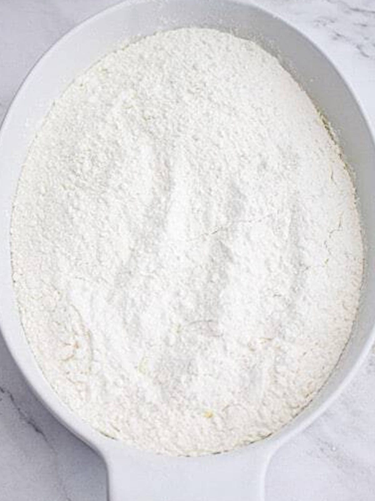 Dry vanilla cake mix sprinkled in an even layer over the dump cake.