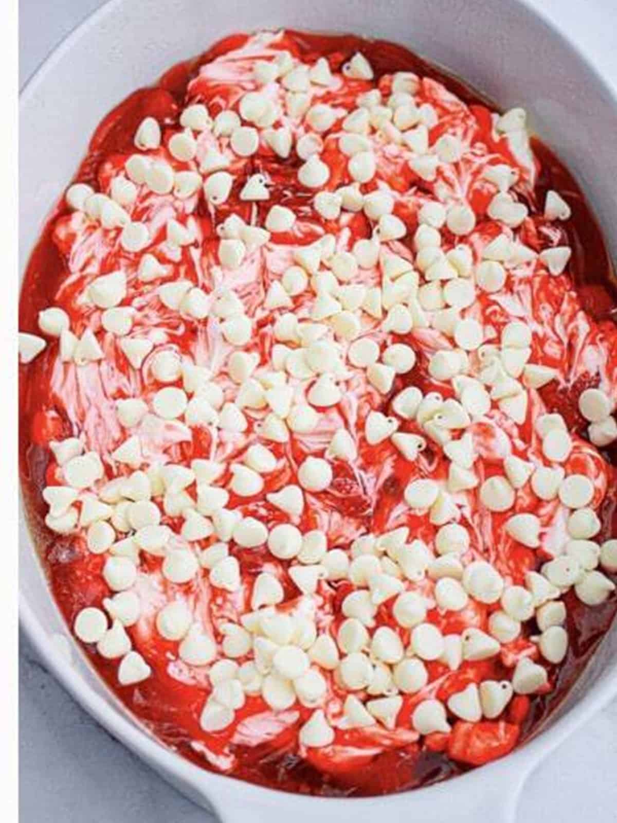 White chocolate chips sprinkled over the strawberry and cream cheese layer.