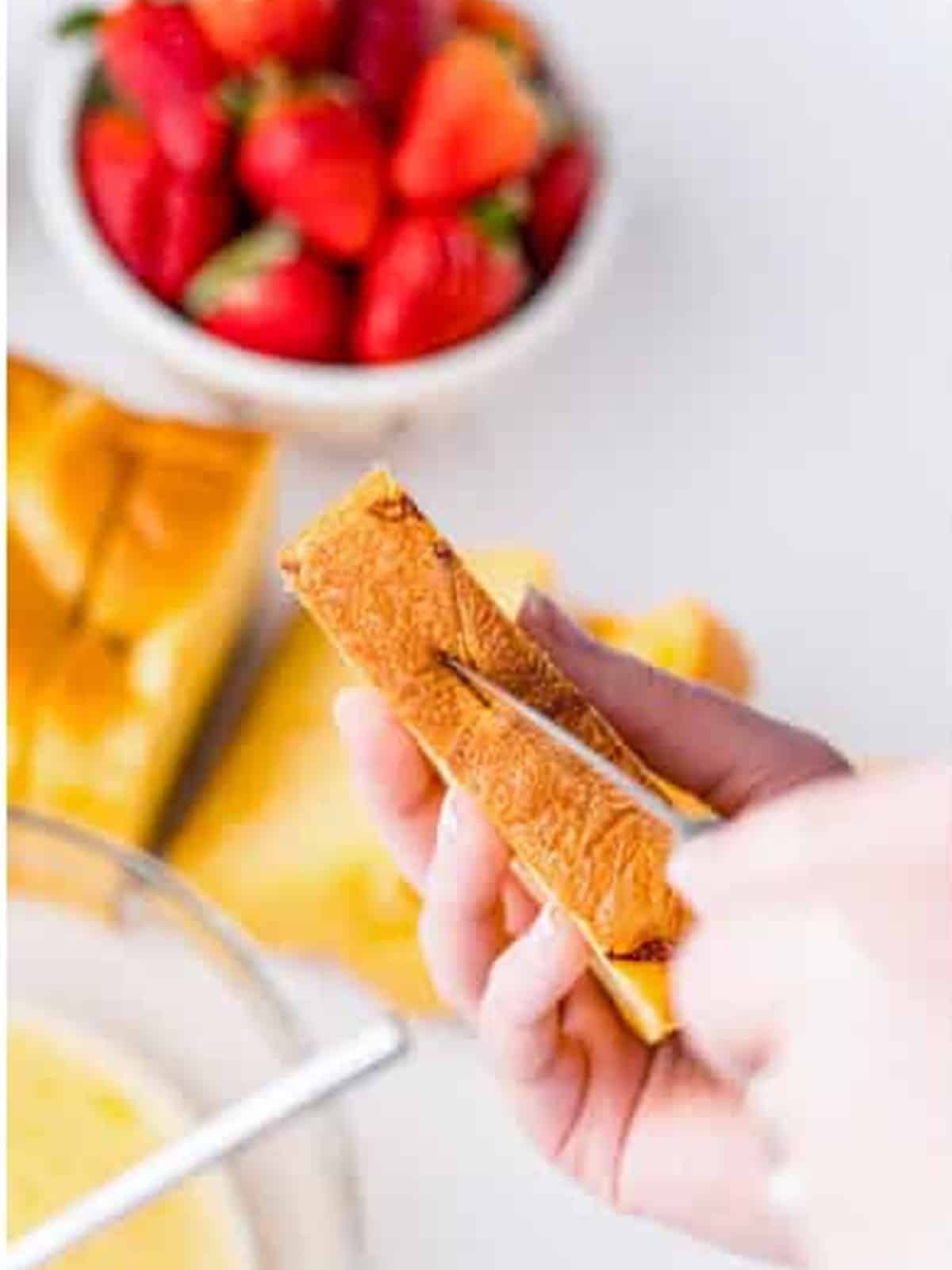 Cutting a slit into the bottom of a brioche bread slice.