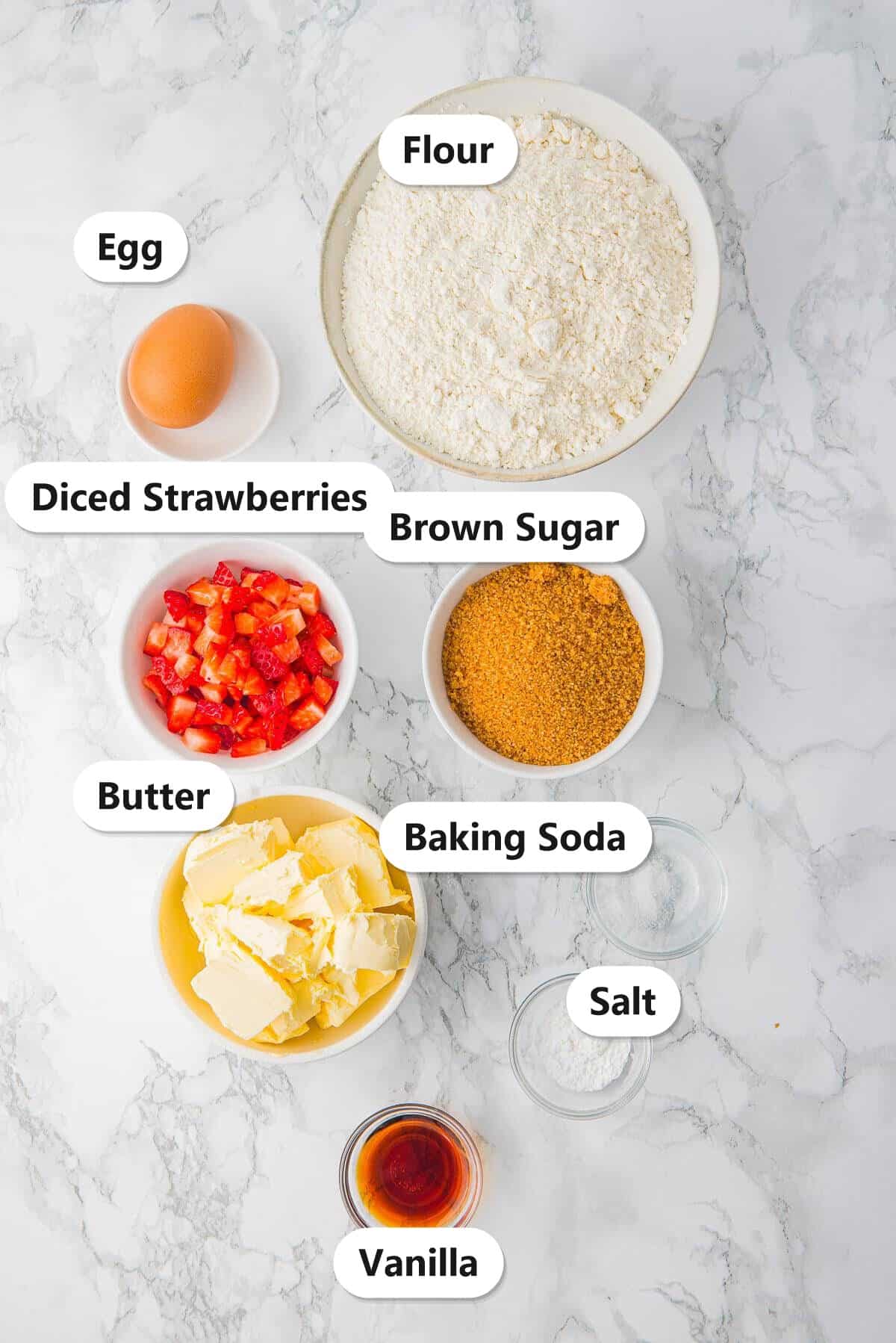 Labeled ingredients for fresh strawberry cookies including flour, butter, brown sugar, an egg, fresh diced strawberries, and vanilla.