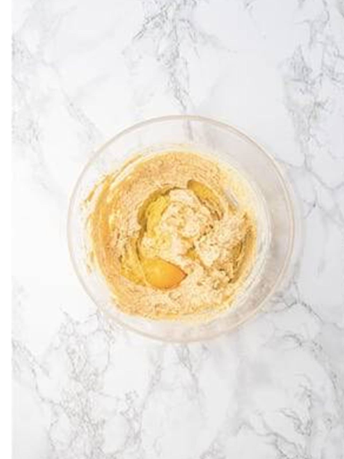 An egg beaten into the creamed butter and sugar for strawberry cookie dough.