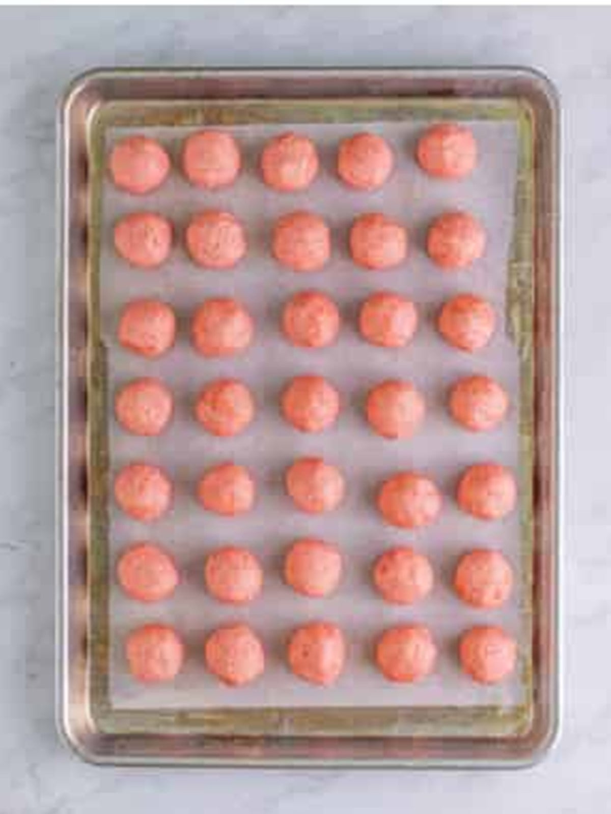 Strawberry Cookies dough rolled into balls on a tray to chill.