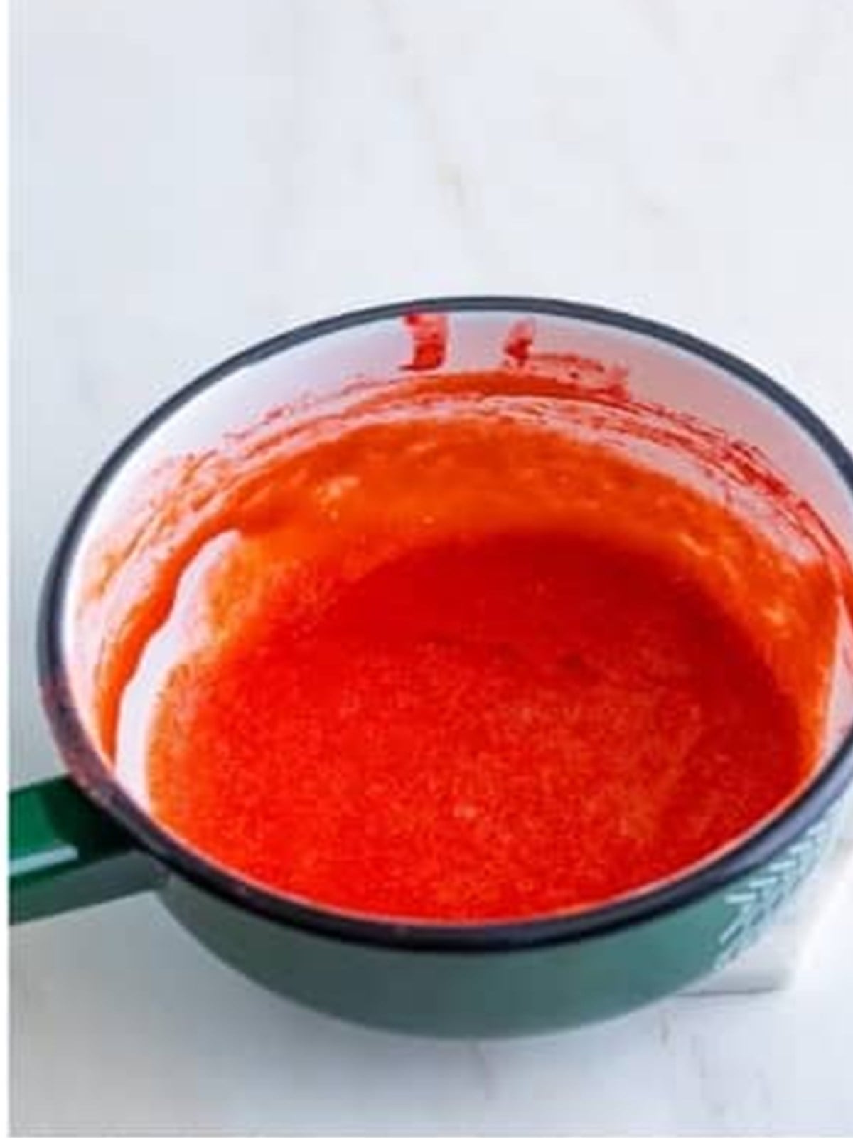 Strawberry puree reduced in a saucepan to concentrate the flavor.
