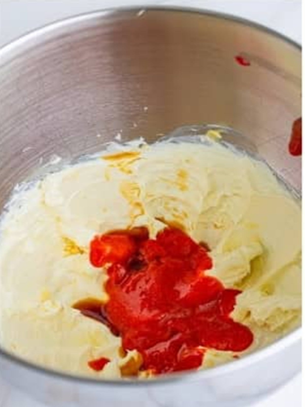 Reduced strawberry puree added to whipped cream cheese and butter.