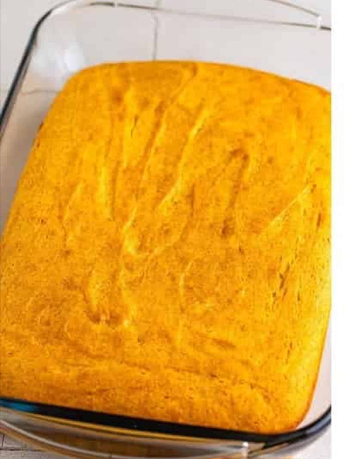 Baked white cake for strawberry poke cake.