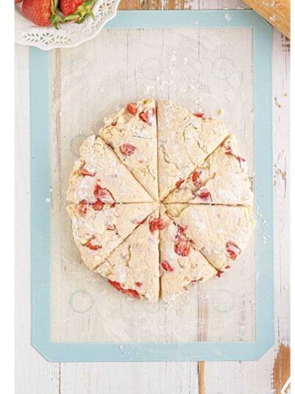 Scone dough shaped into a circle and cut into eight triangles.