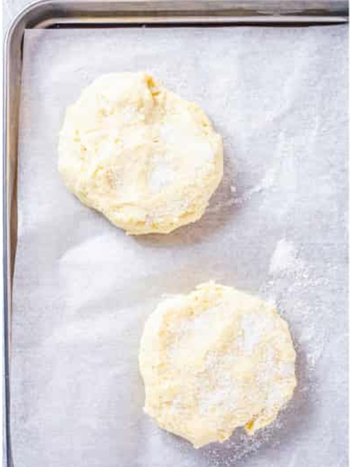 Free-form drop biscuits on a baking sheet ready to bake for strawberry shortcake.