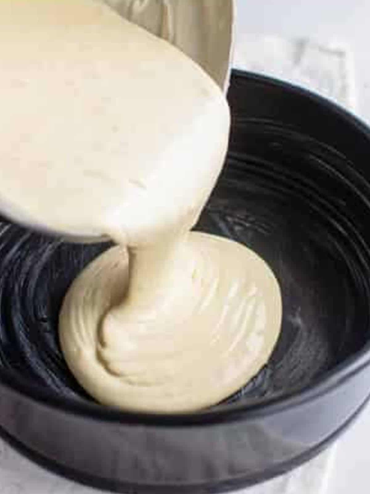 Cheesecake batter poured into a springform pan before baking.