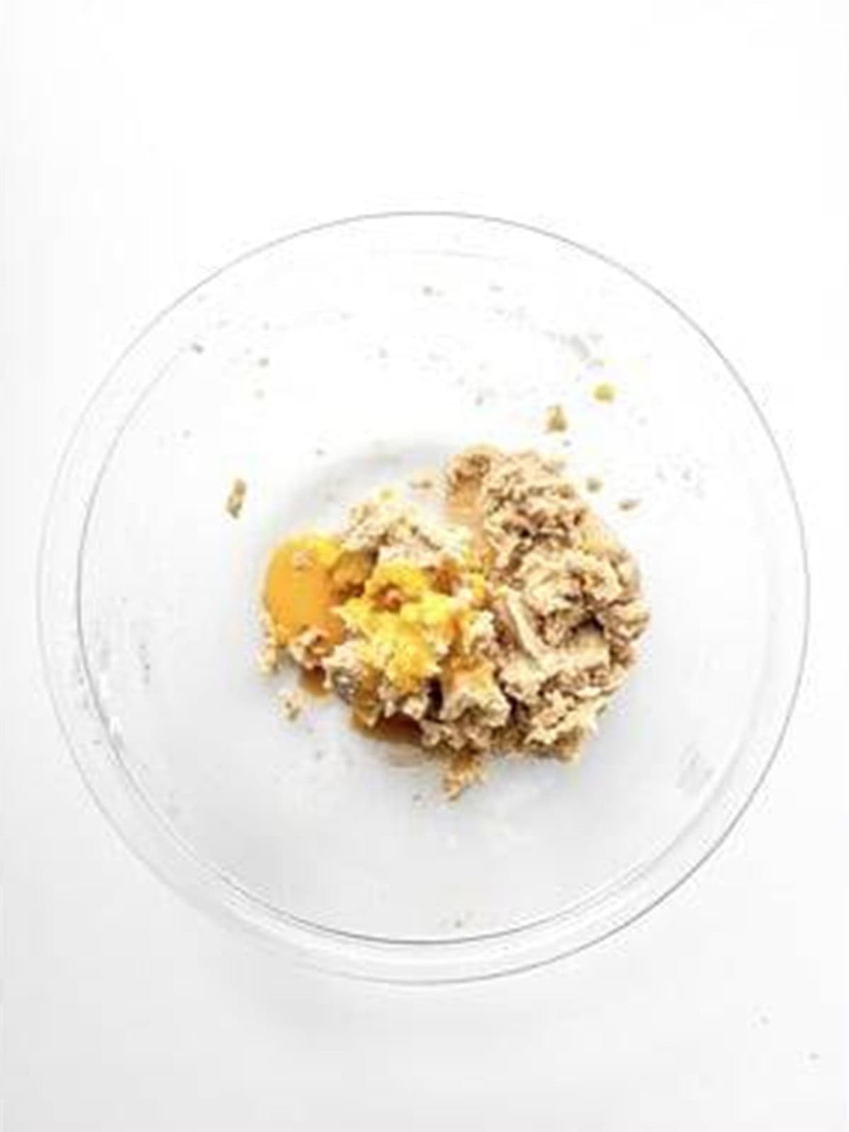 Egg, egg yolk, and extracts added to the creamed butter and sugar.