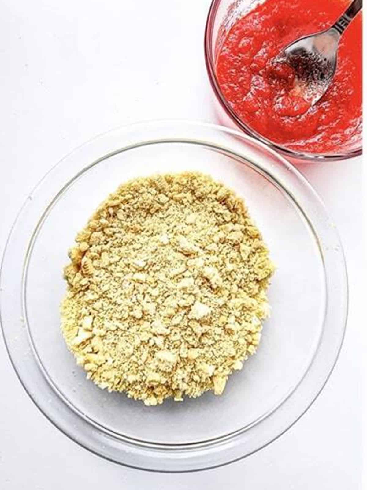Golden Oreos pulsed into coarse crumbs in a bowl for strawberry crunch.