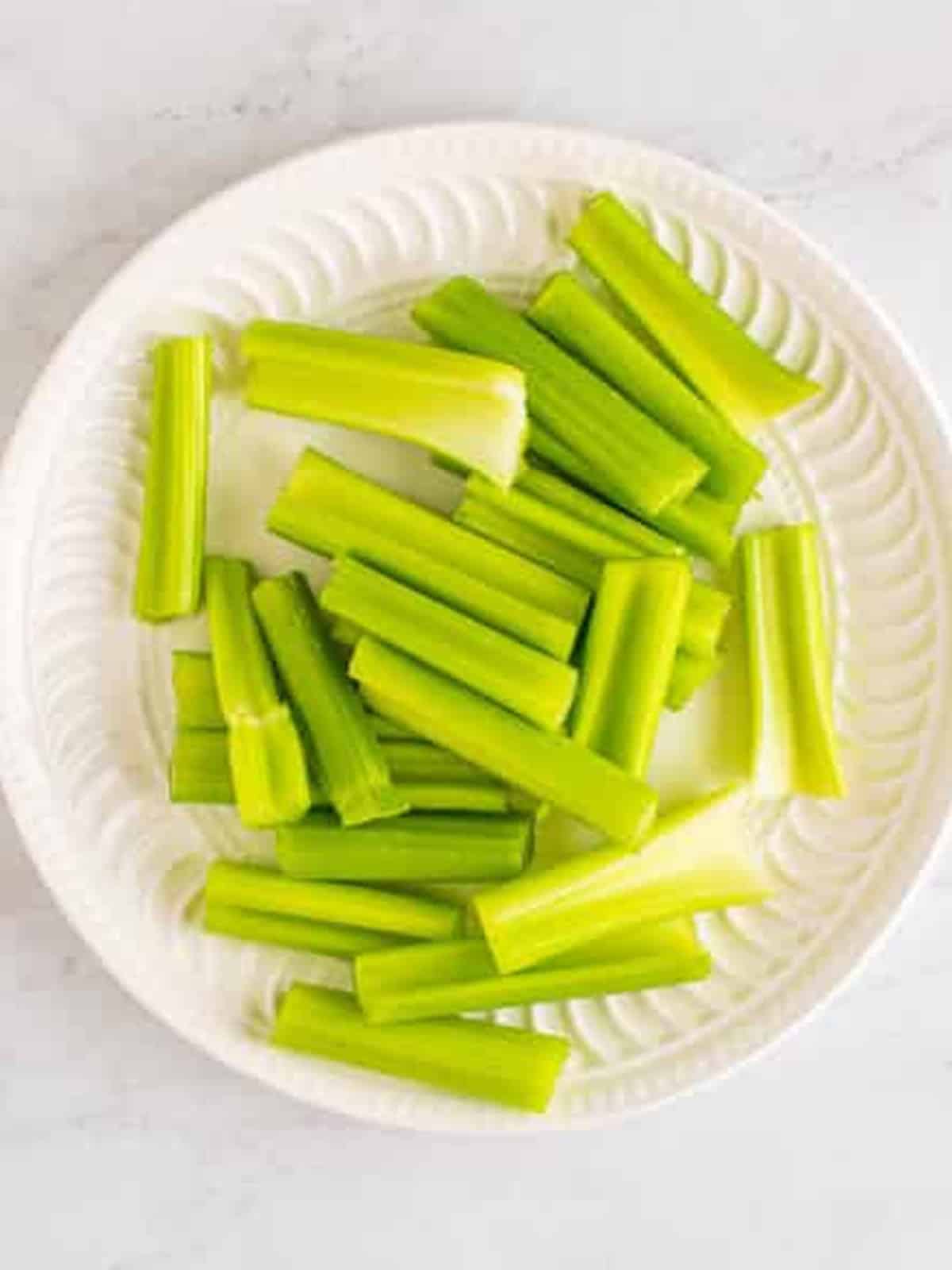 Fresh celery stalks washed and cut into bite-size pieces for stuffed celery sticks.
