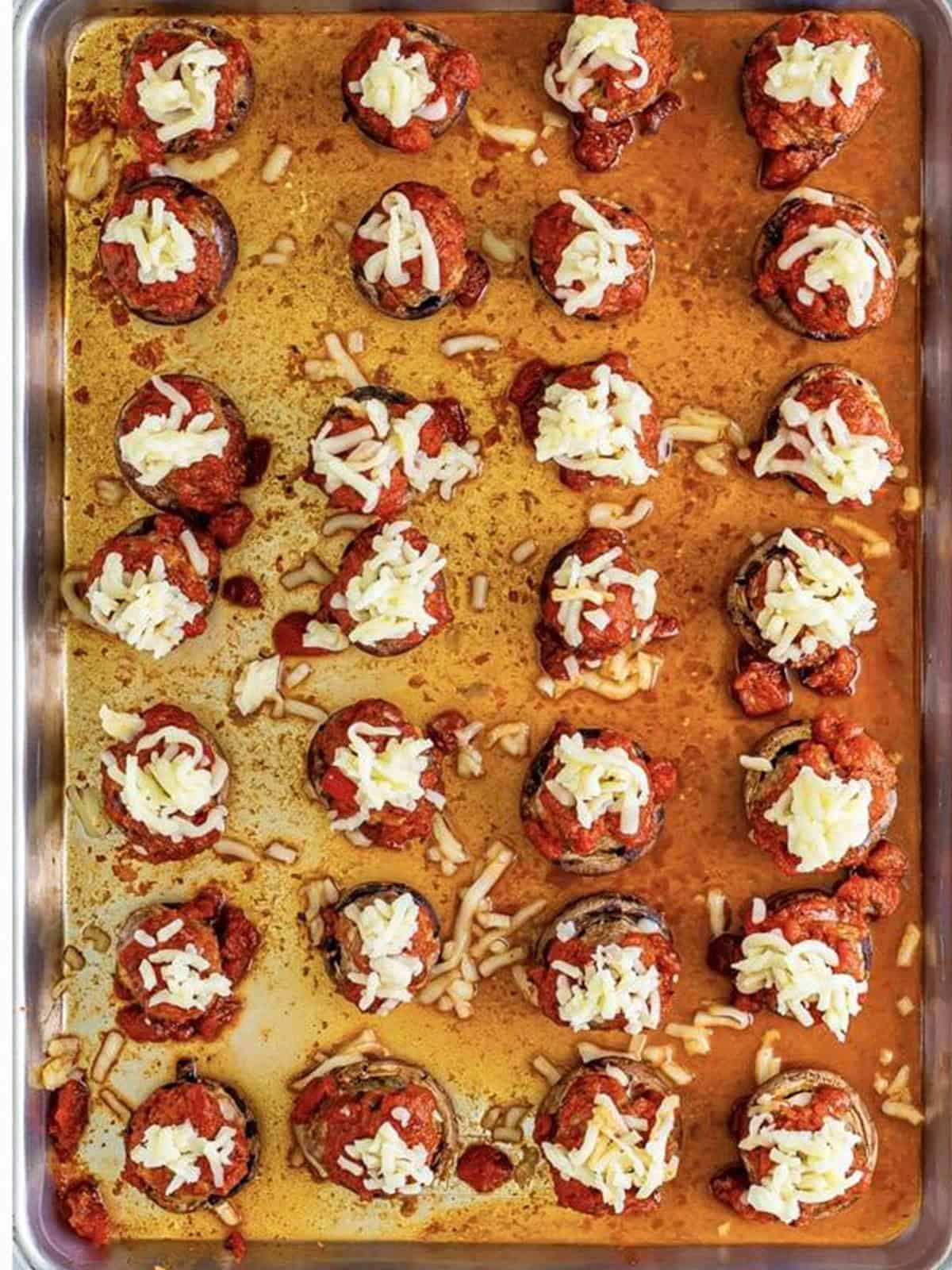 Baked Italian stuffed mushrooms topped with melted mozzarella cheese.
