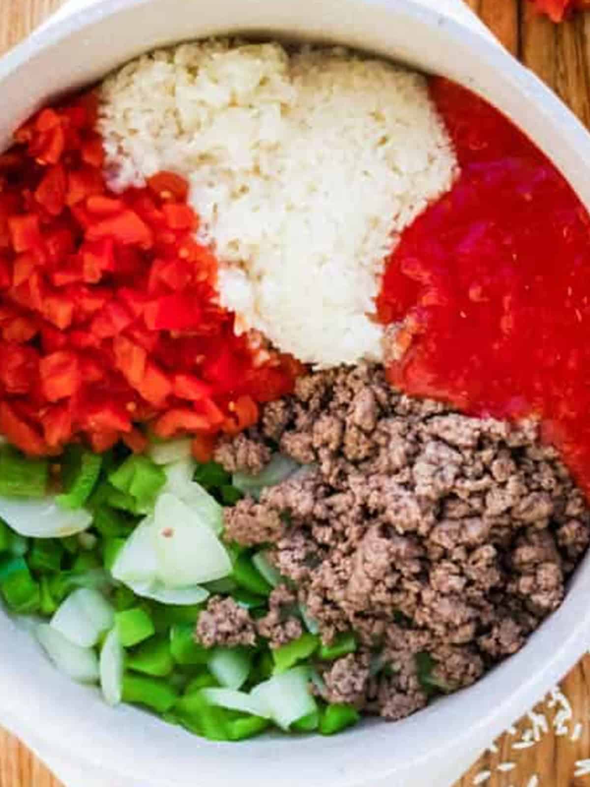 Ground beef, rice, diced red peppers, tomatoes, green peppers, and onion added to the pot for stuffed pepper soup.