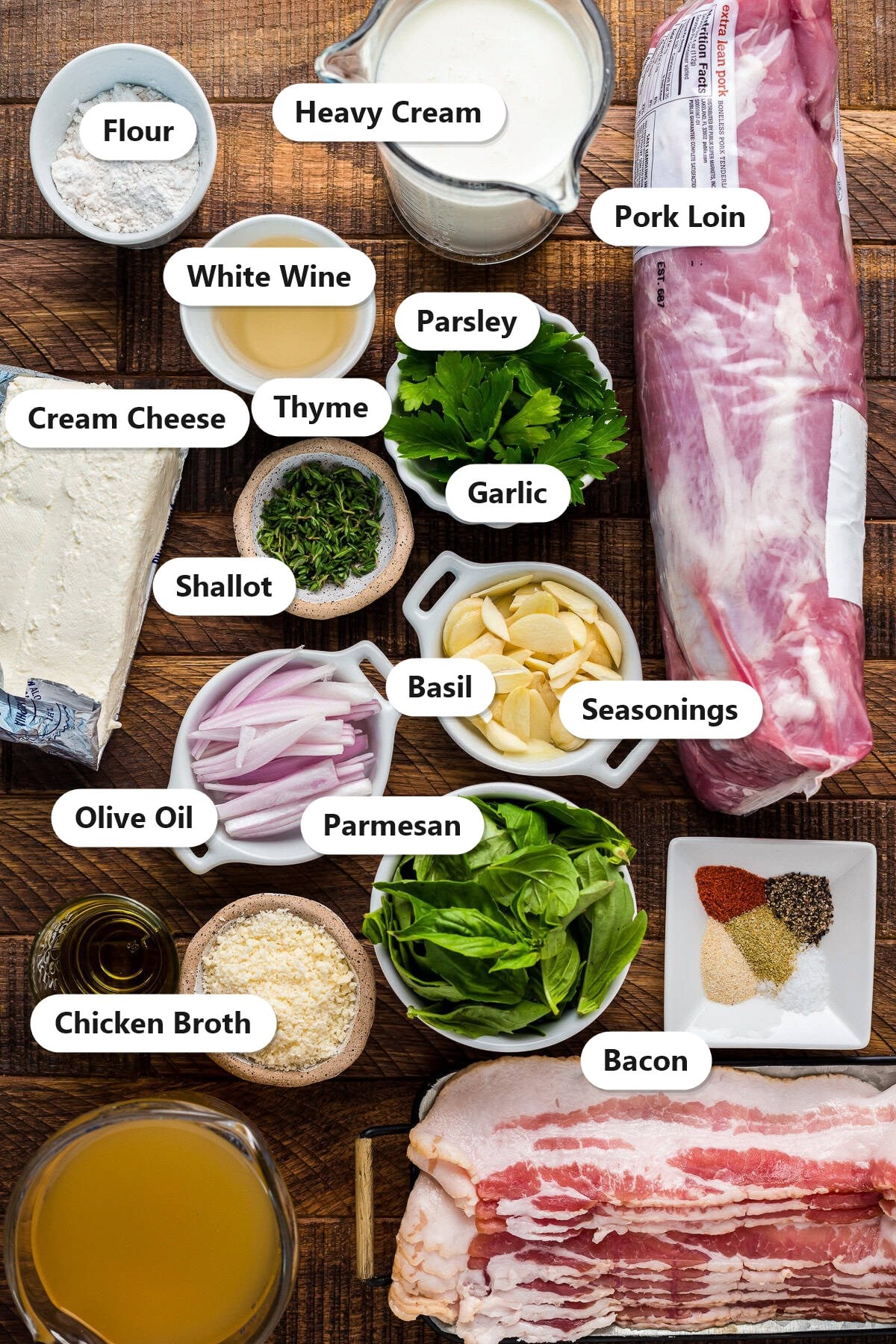 Labeled ingredients for stuffed pork loin including pork loin, bacon, cream cheese, parmesan, herbs, shallot, garlic, heavy cream, white wine, and chicken broth.