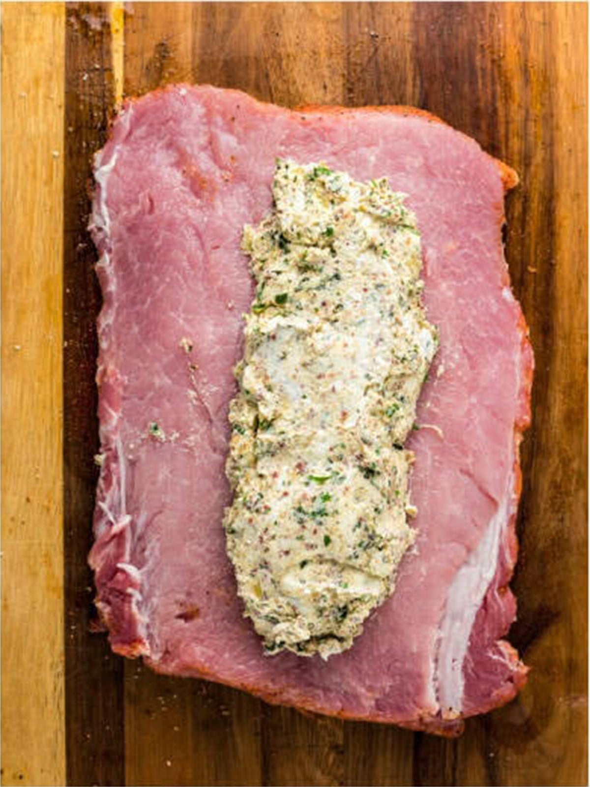 Cream cheese filling spread over the seasoned pork loin.