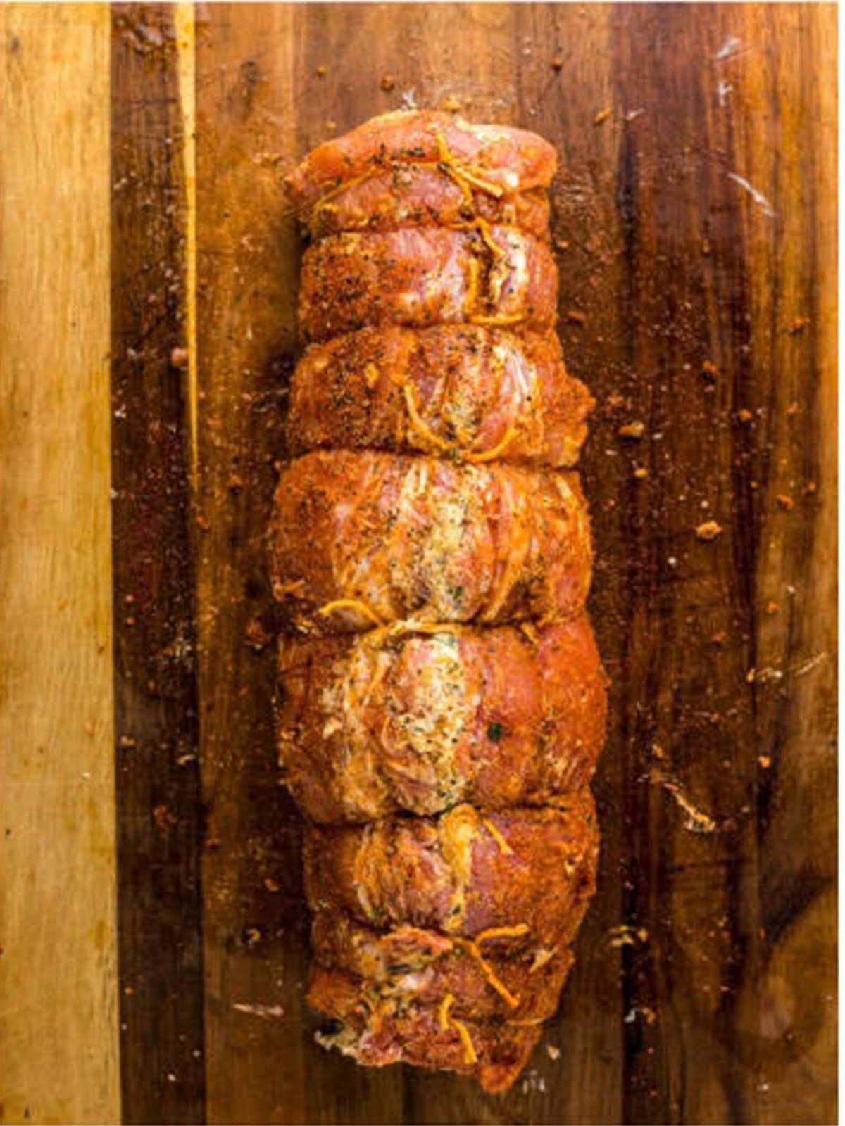 Stuffed pork loin rolled into a log and tied with twine.