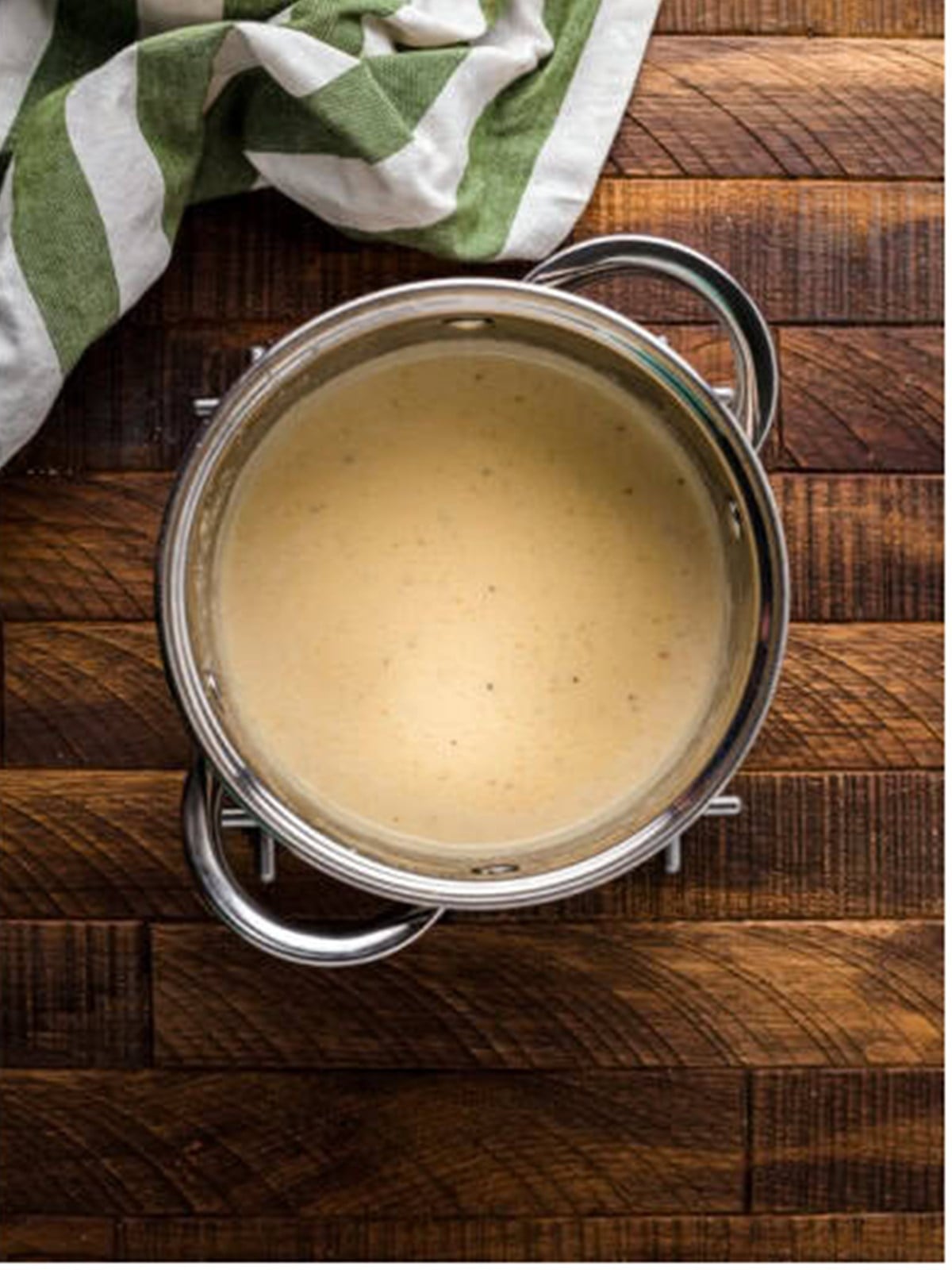 Creamy white wine pan sauce in a saucepan.