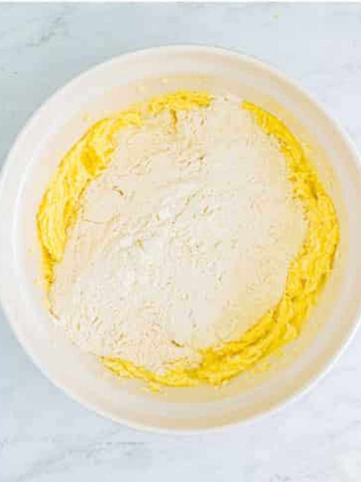 Adding flour and dry ingredients to sugar cookie dough