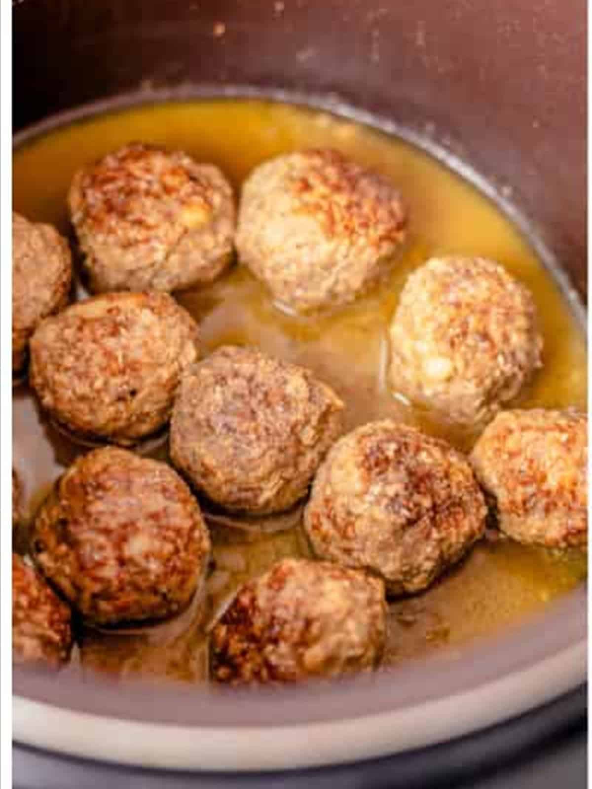 Browned Swedish meatballs in the slow cooker with sauce.