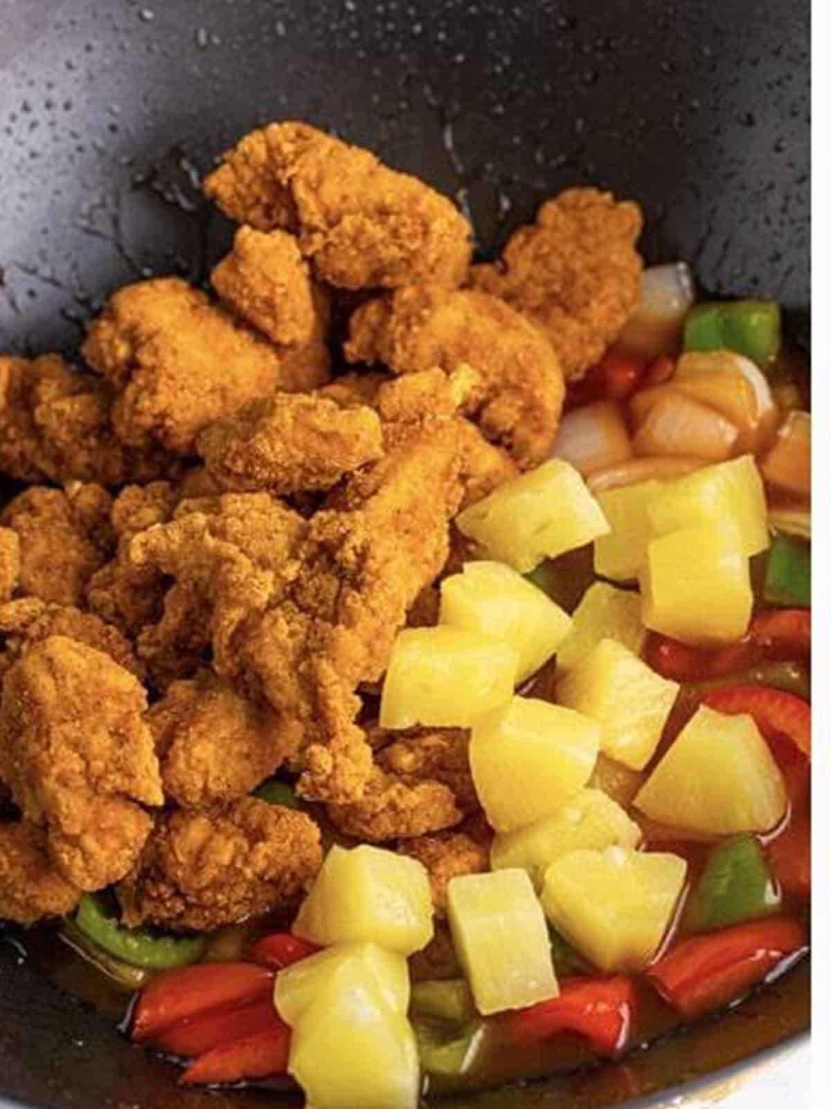 Crispy popcorn chicken and pineapple chunks added to the sweet and sour sauce.