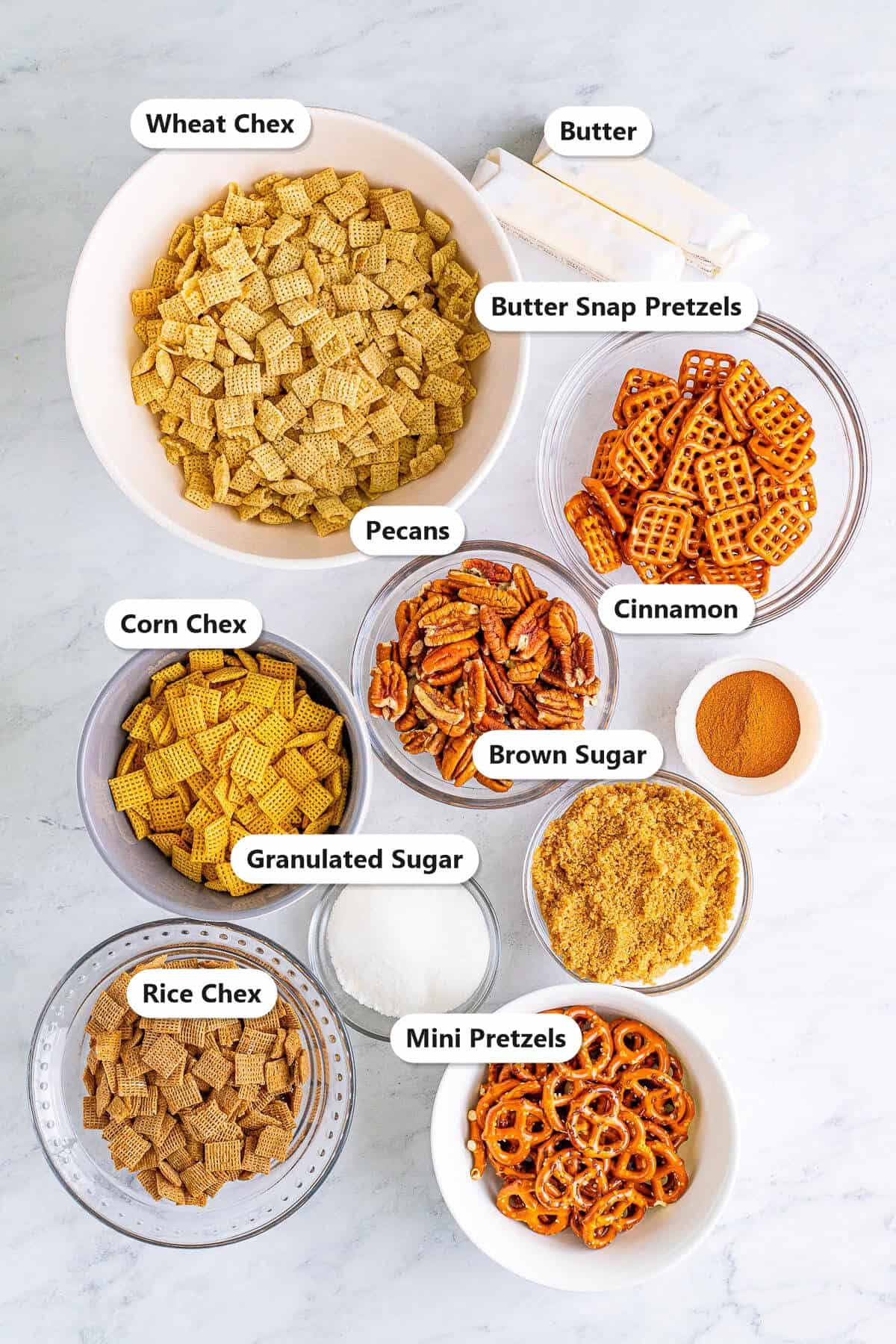 Wheat, corn, and rice Chex, pretzels, pecans, butter, brown sugar, granulated sugar, and cinnamon labeled for Sweet Chex Mix.