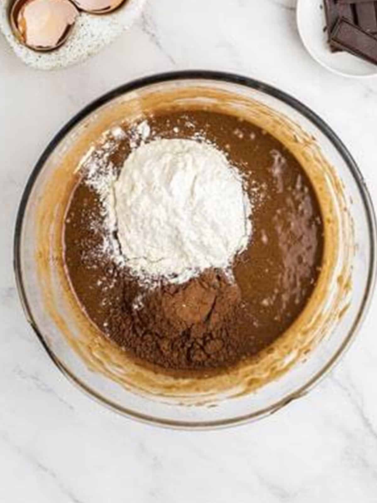 Flour and cocoa powder added to the sweet potato brownie batter.