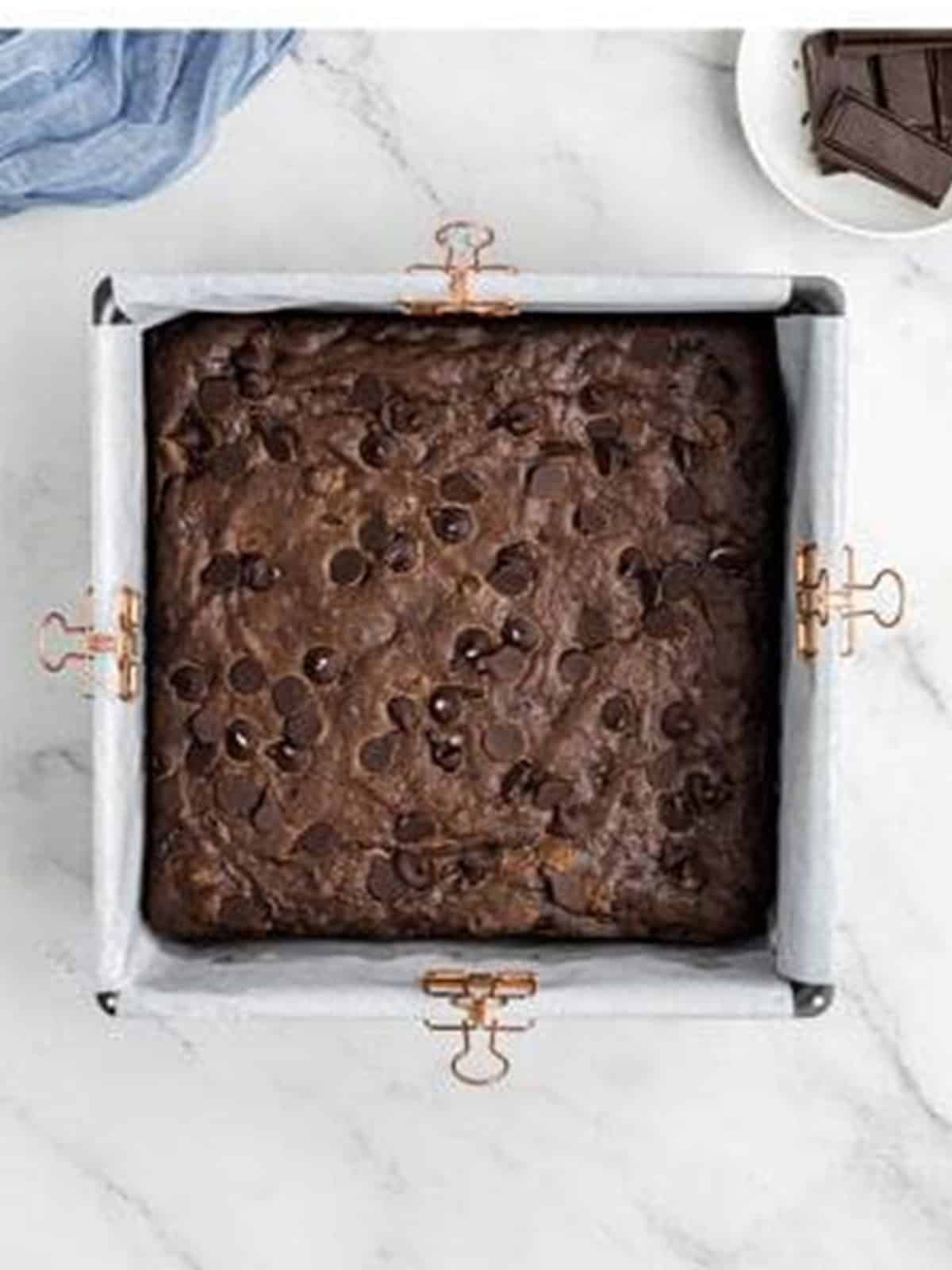 Sweet potato brownie batter topped with chocolate chips before baking.