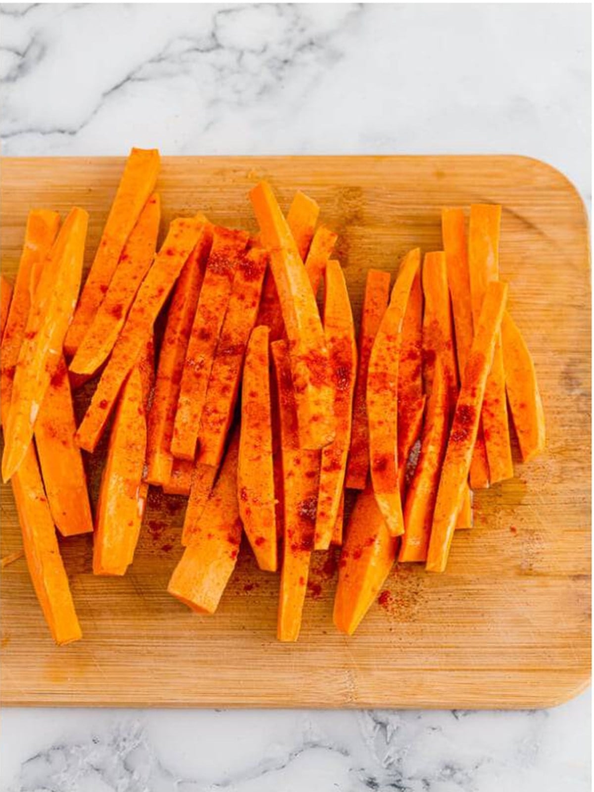 Sweet potato sticks tossed with oil, salt, and paprika