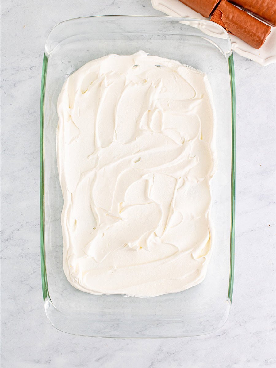 Cool whip spread in the bottom of a glass baking dish.