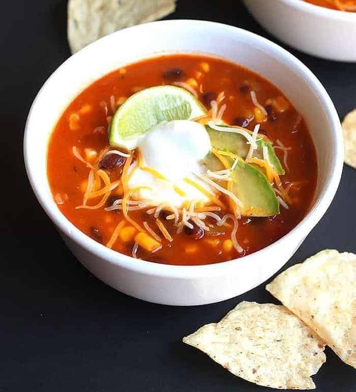A bowl of Taco Soup with tortilla chips on the side.