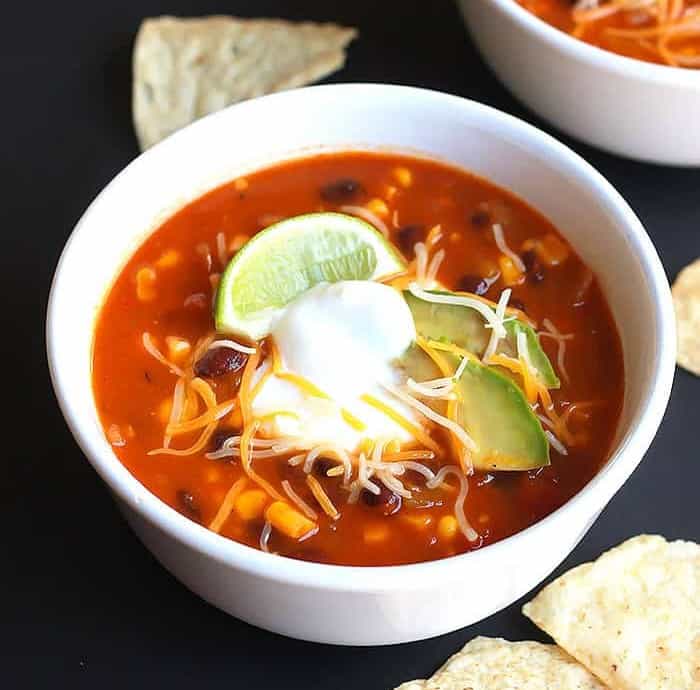 Two bowls of hearty Taco Soup served with tortilla chips.