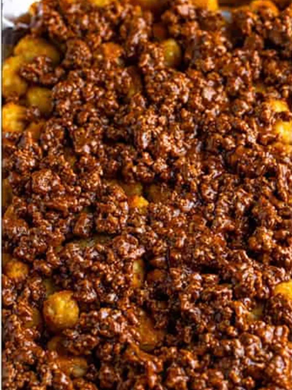 Seasoned ground beef spread over the tater tots.