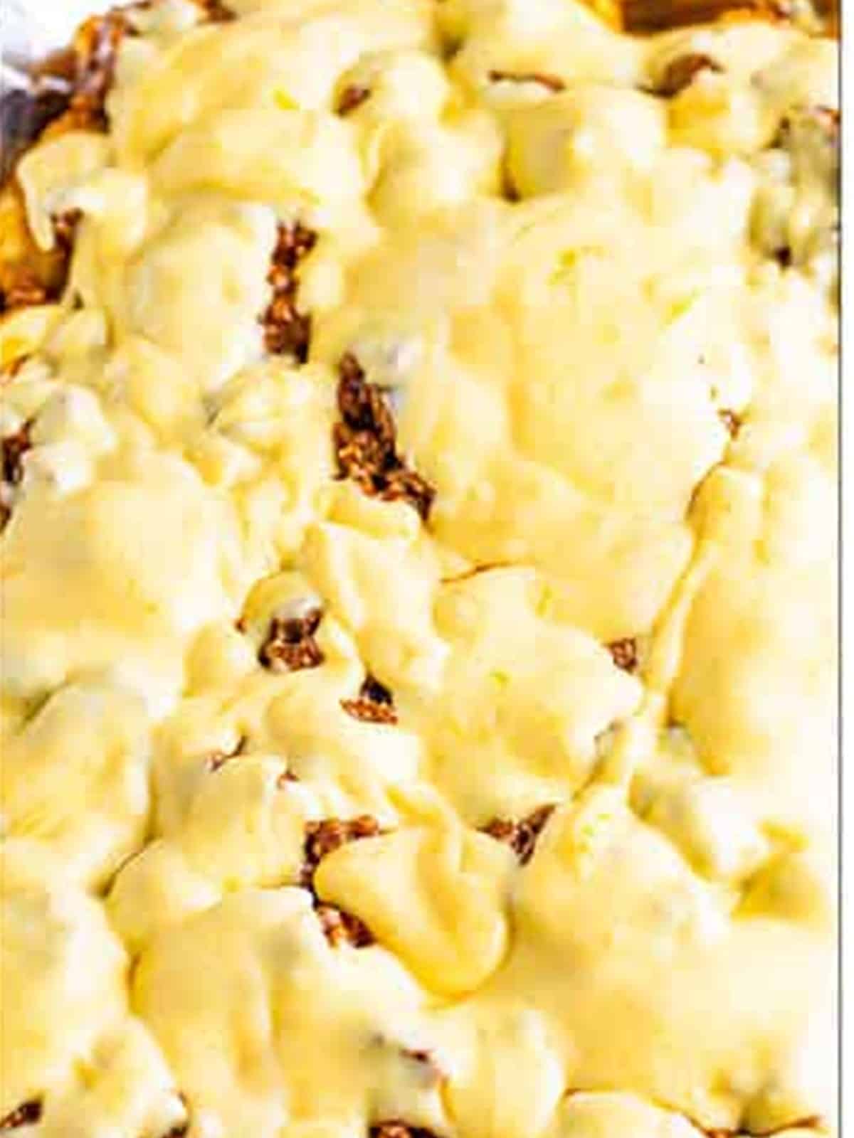 Drizzling cheese sauce over the loaded Tater Tot Nachos.