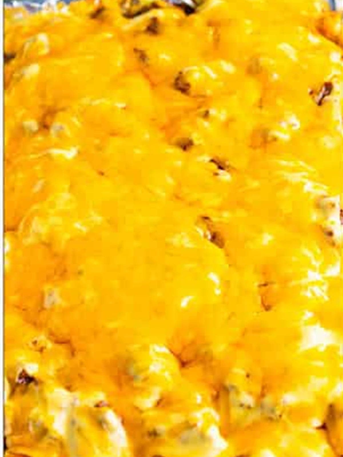 Shredded cheddar melted over the finished Tater Tot Nachos.