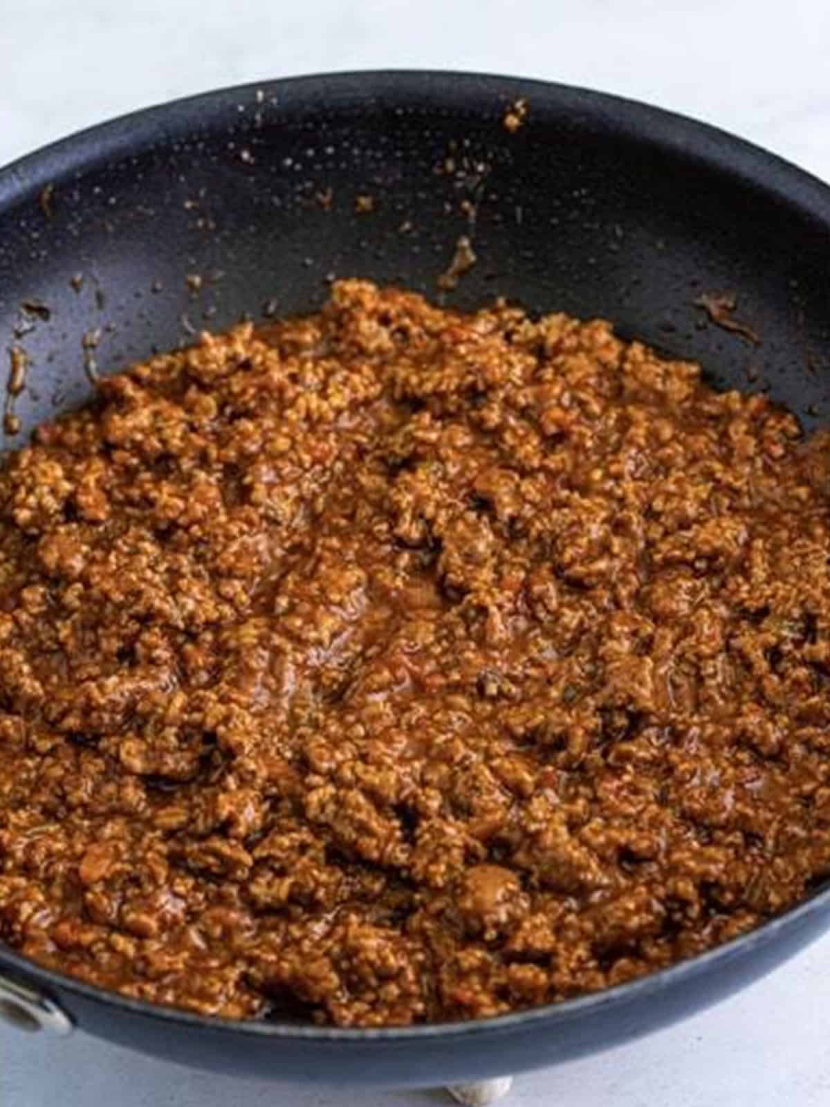 Finished taco meat simmered in a skillet.