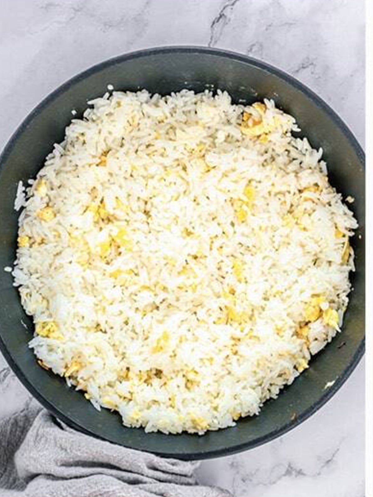 Cooked rice added to the skillet and fried until toasted.